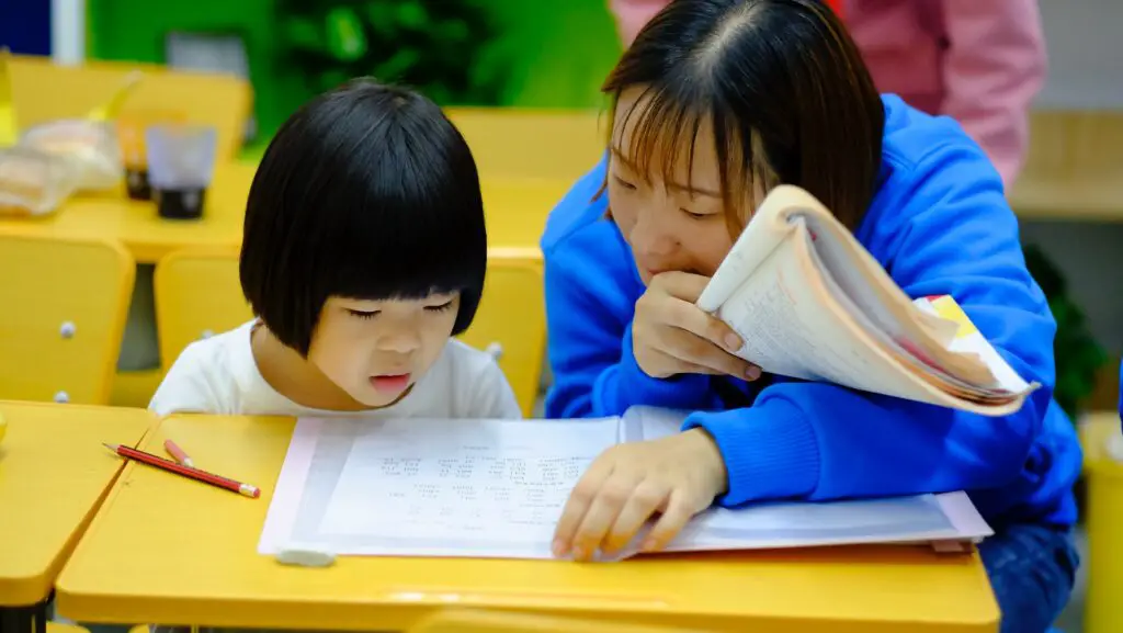 A teacher helping a student