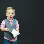 a boy holding a book