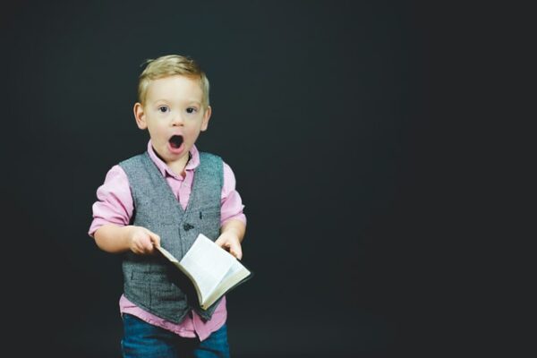 a boy holding a book