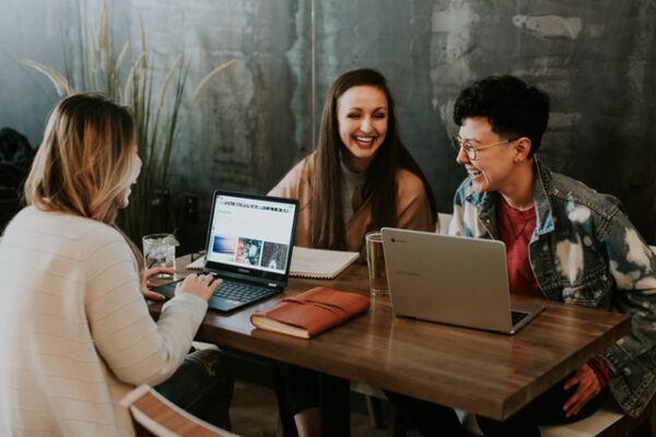 two women and a man talking