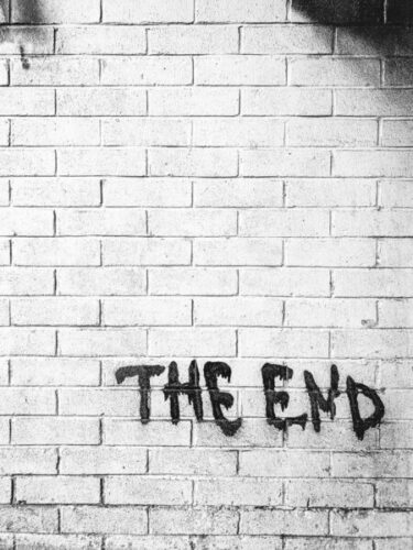 "the end" written on a brick wall
