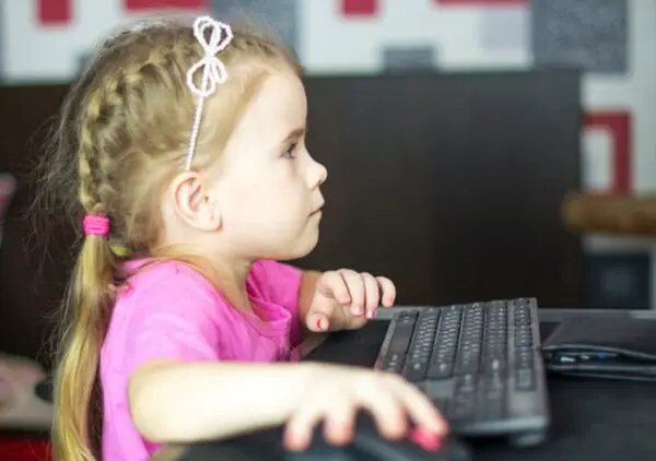 a small girl using a computer