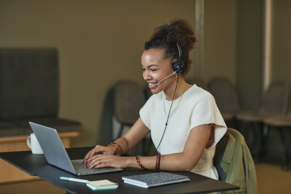 a girl practicing pte speaking in front of a laptop